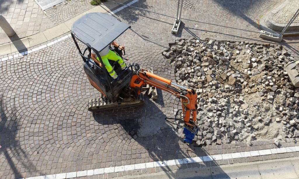 An aerial view of a road construction site - digging the Cobblestones