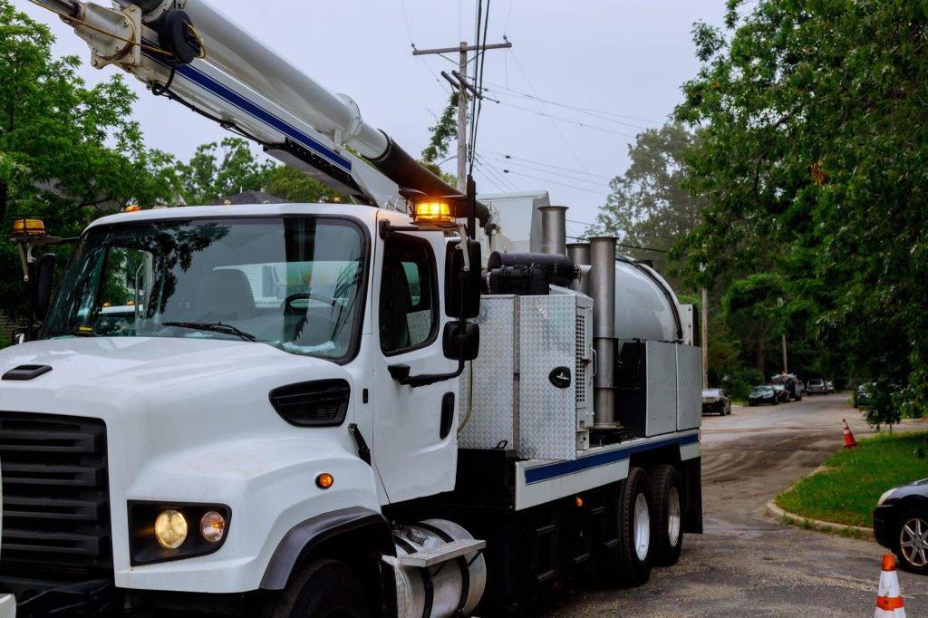 Sewage industrial cleaning truck clean blockage in a sewer line machine from the inside.
