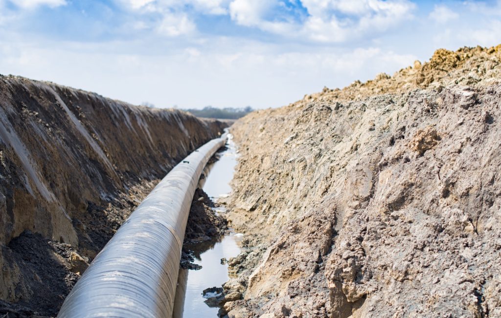 Natural gas pipeline construction work. A dug trench in the ground for the installation and installation of industrial gas and oil pipes. Underground work project
