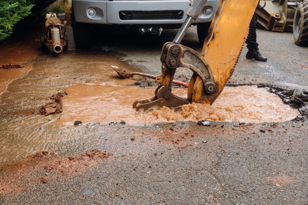 Splatter of water from broken pipe the main road water leaking from hole